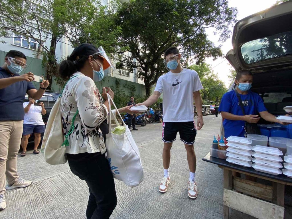 CJ Cansino distributing goods in a community pantry in UP Diliman